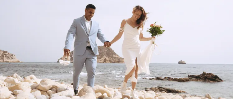 Speaking vows during their hiking and beach elopement in Spain with view of the mediterranean sea. Elopement stories